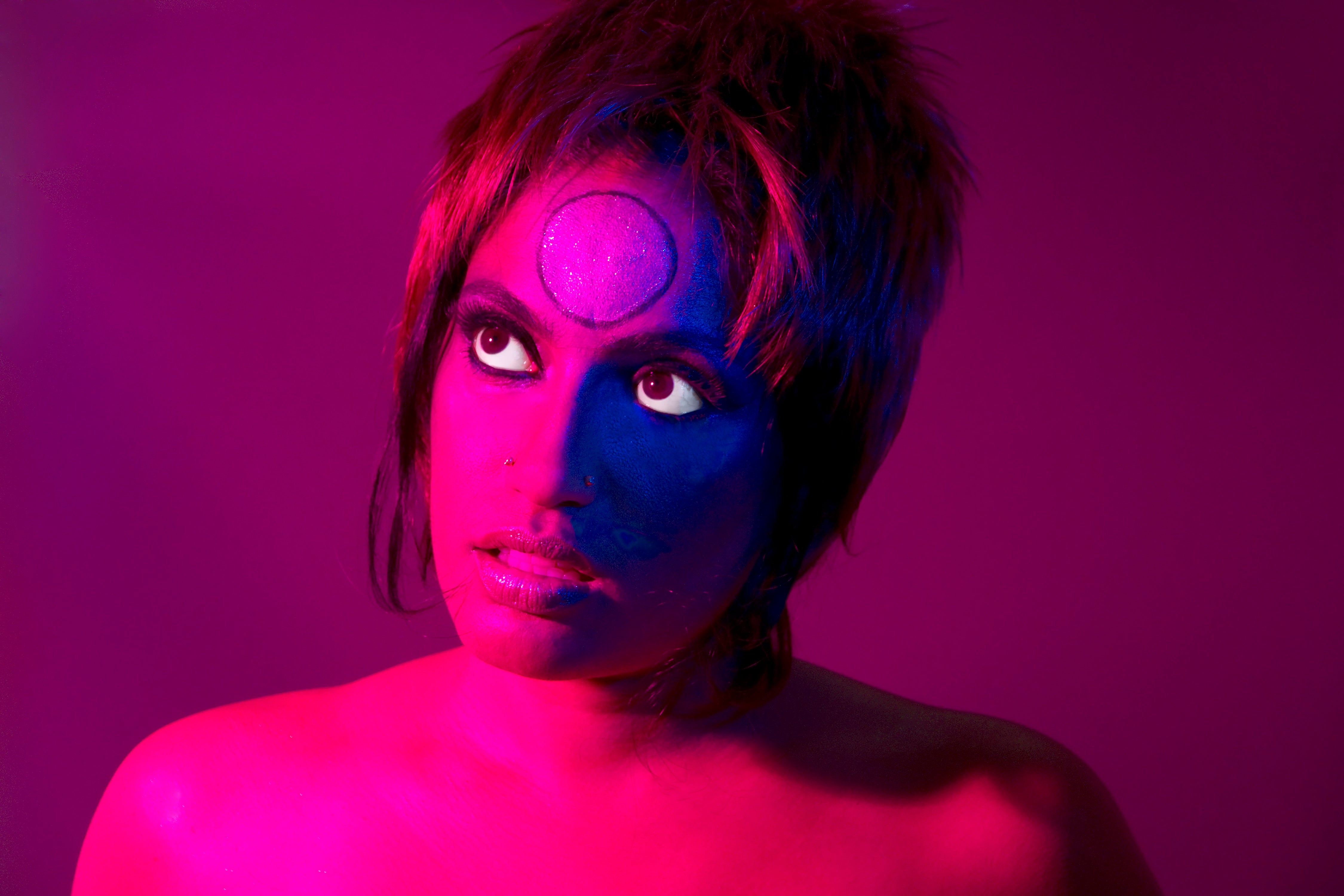 Elia Alba, Visual Arts Center, close-up portrait of woman with pink lighting