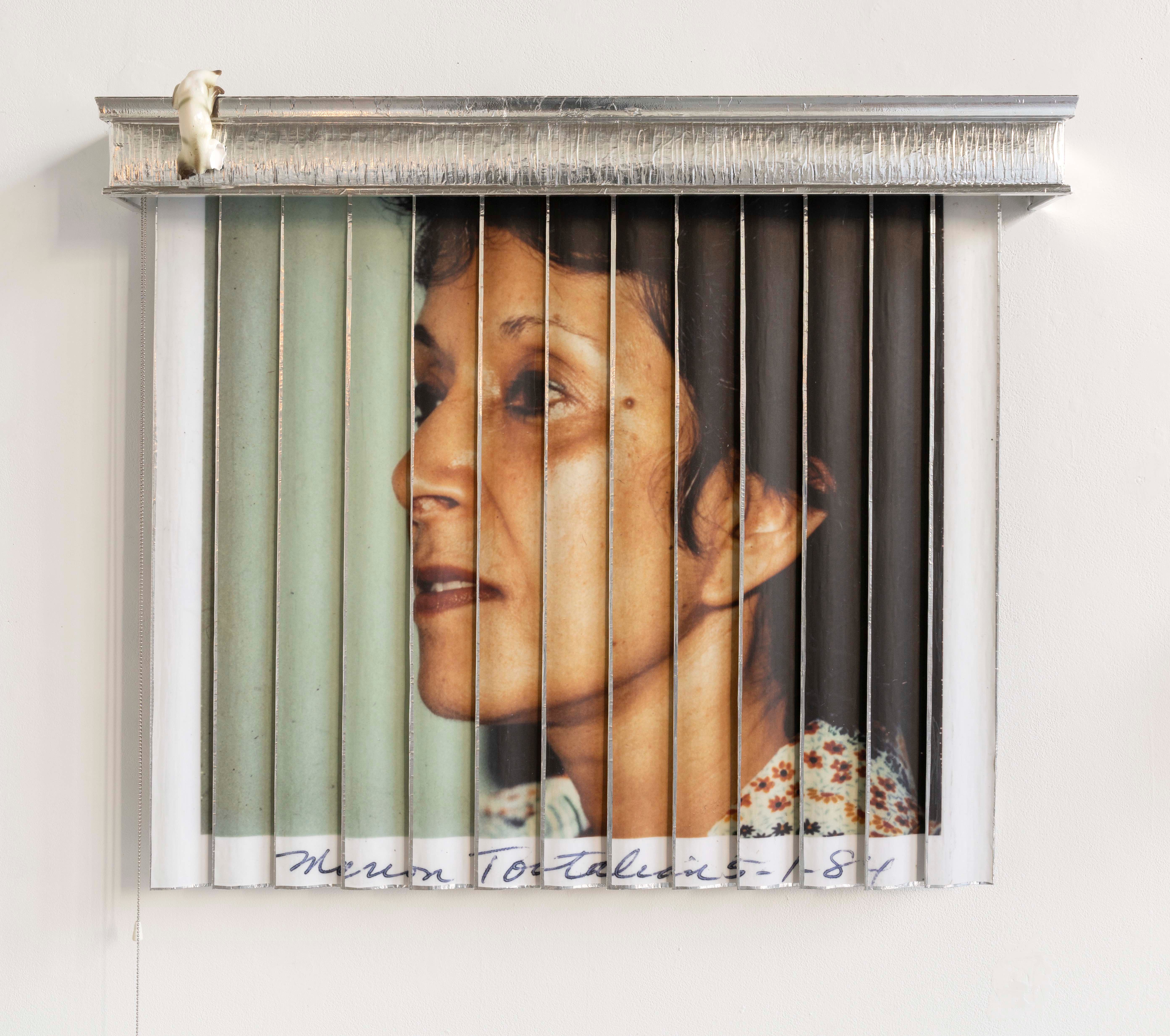 Image of a photo of a woman on the wall.