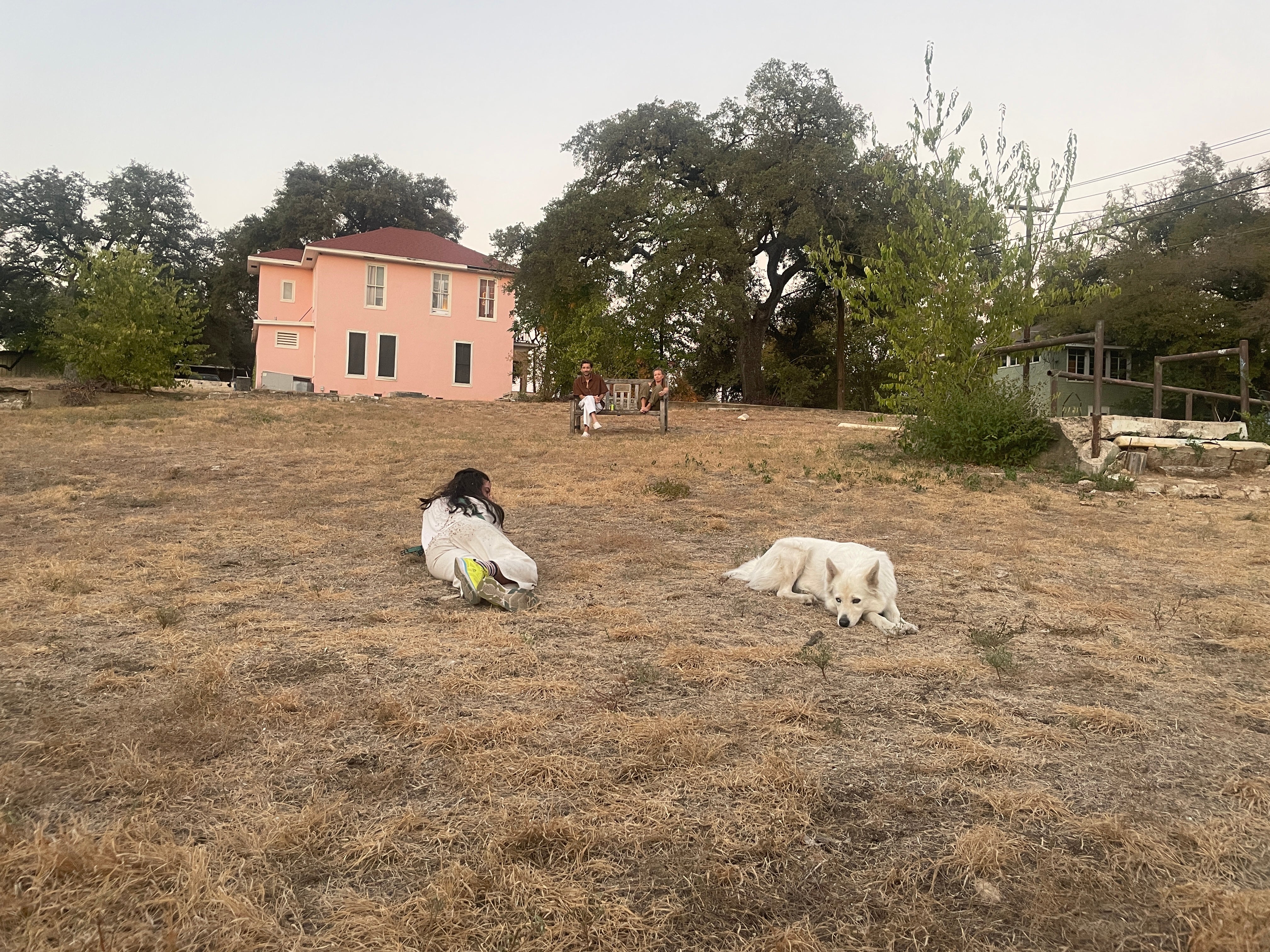 image of a person and their dog laying in a field