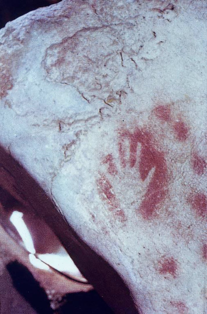photo of prehistoric stone with handprint outlined in red