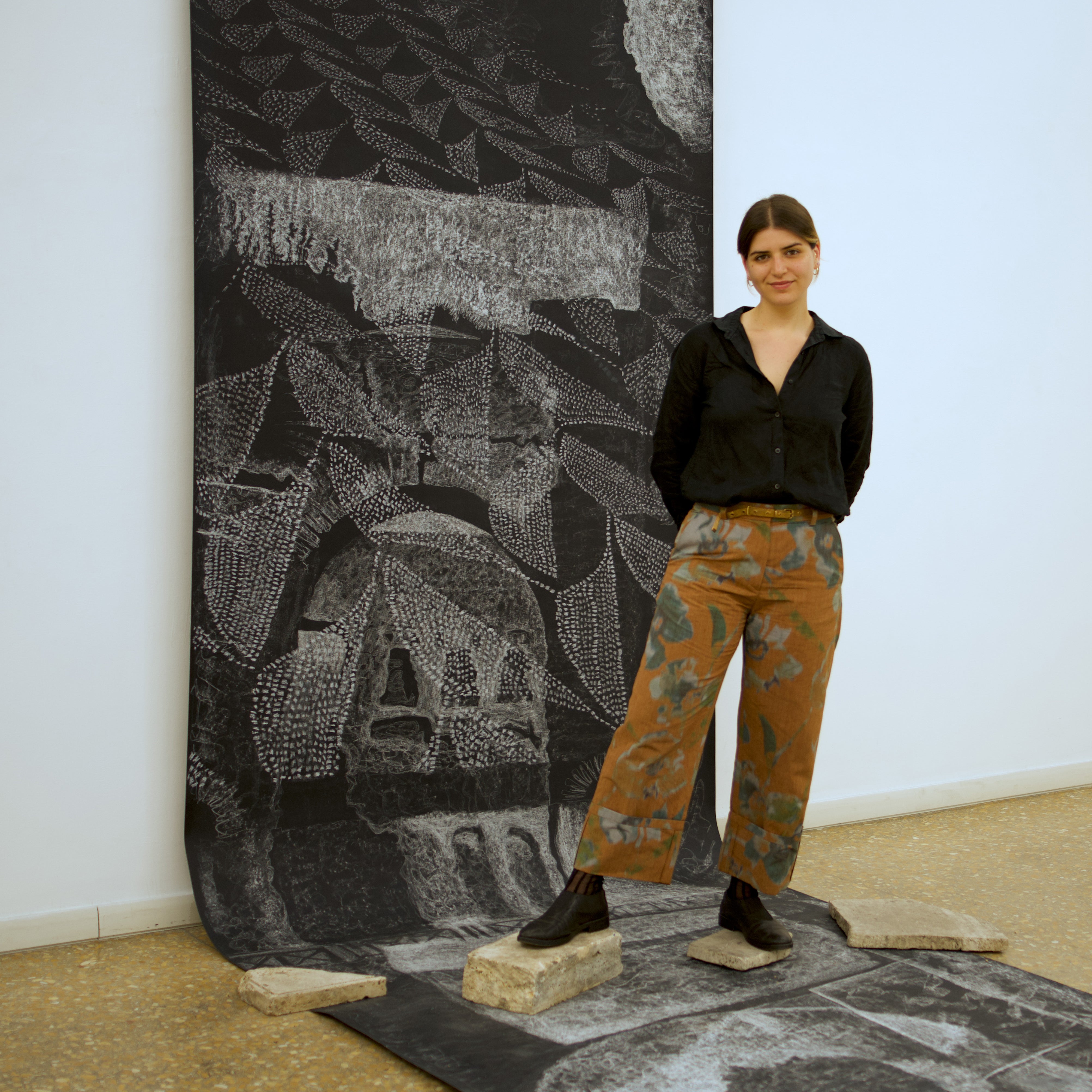 image of a person standing in front of an artwork