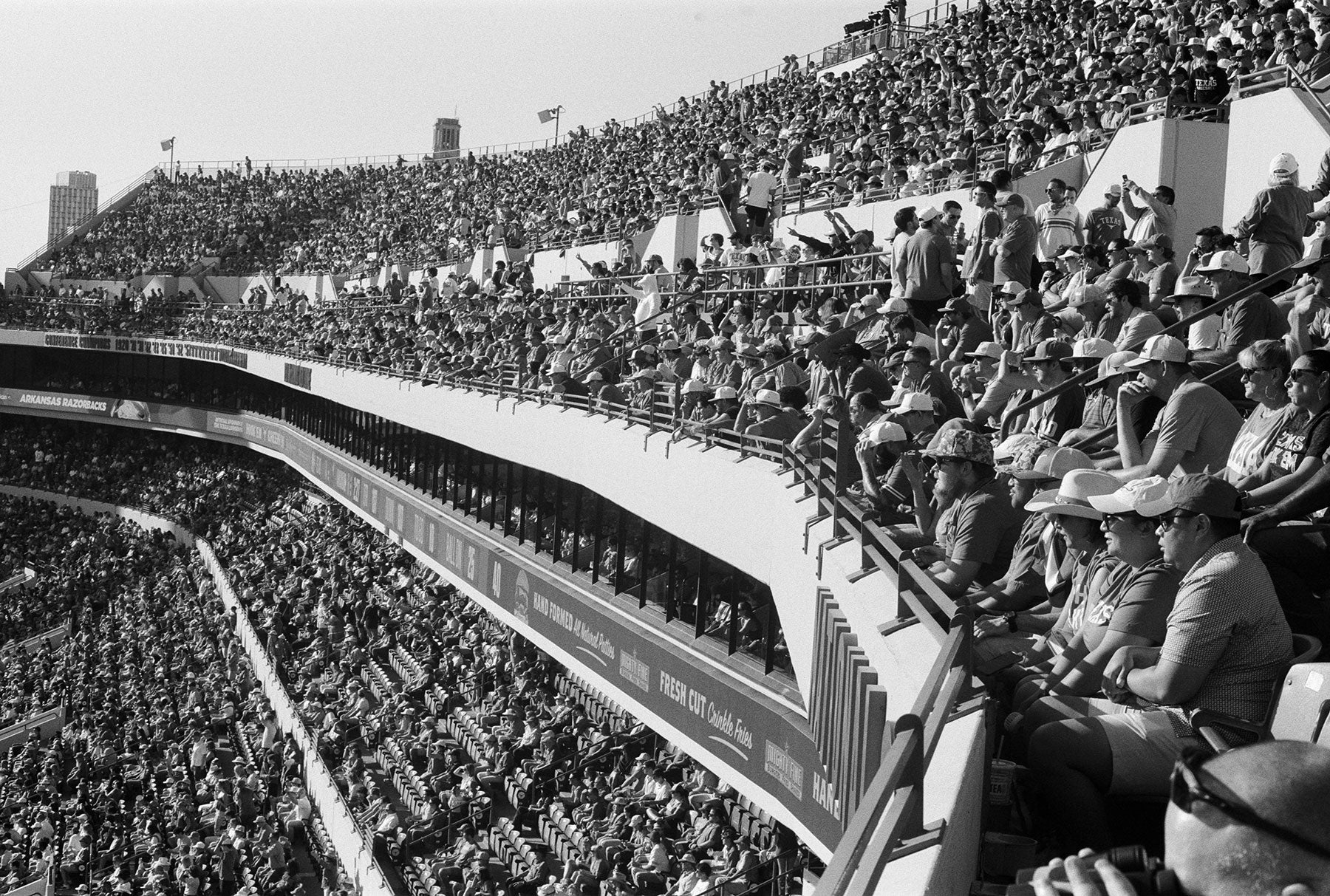 spectator crowd seated in the upper tiers of a football stadium