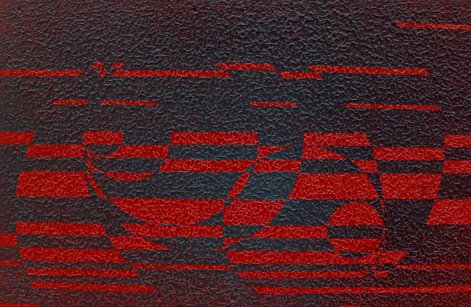 artwork that includes geometric pattern in black and red with a visibly textured surface