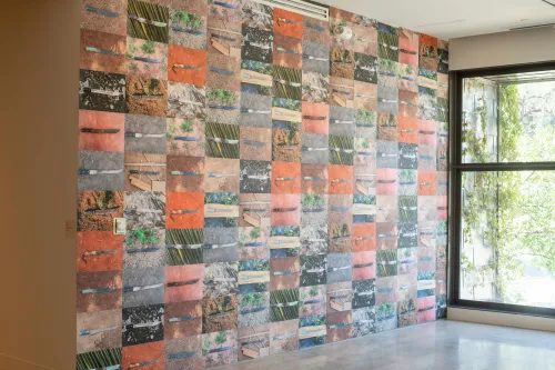 wall filled with images of machetes on the ground