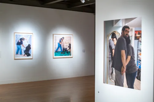 Installation view of El Otro Lado. Framed photographs and PhotoTex on walls.
