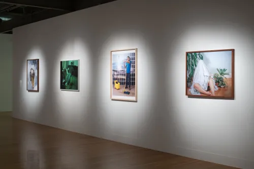 Installation view of El Otro Lado. Framed photographs and PhotoTex on walls.