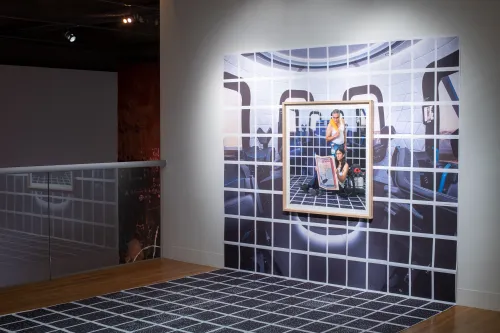 Installation view of El Otro Lado. Framed photographs and PhotoTex on walls.