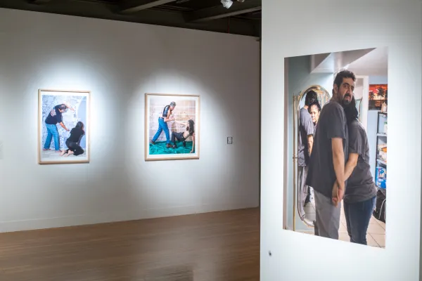 Installation view of El Otro Lado. Framed photographs and PhotoTex on walls.