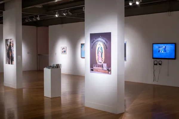 Installation view of El Otro Lado. Framed photographs and PhotoTex on walls.