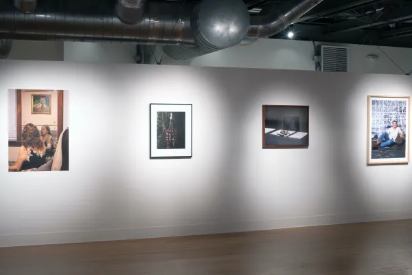 Installation view of El Otro Lado. Framed photographs and PhotoTex on walls.