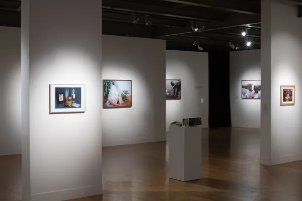 Installation view of El Otro Lado. Framed photographs and PhotoTex on walls.