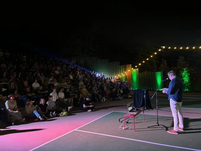 image of a person presenting to a crowd