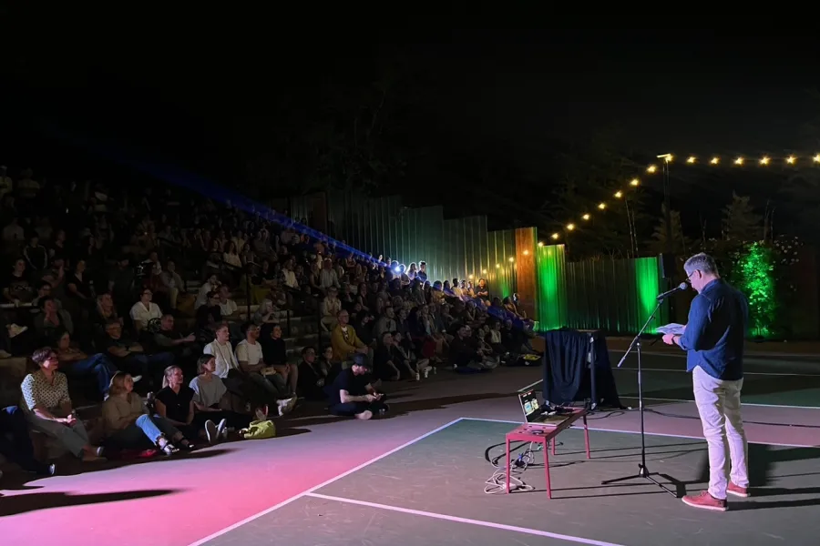 image of a person presenting to a crowd