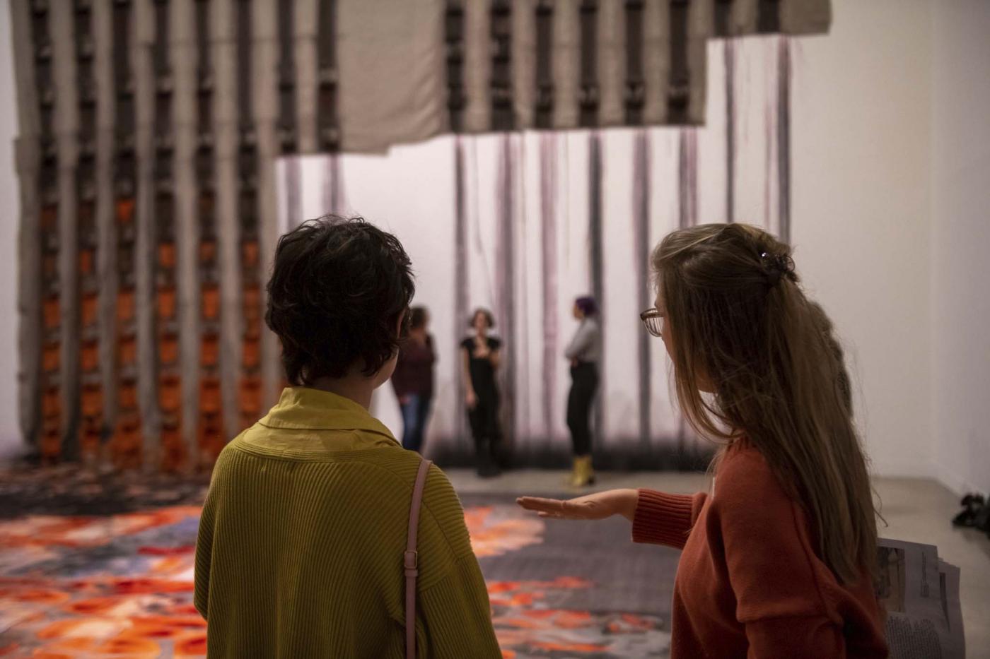 two people looking at art installation in gallery