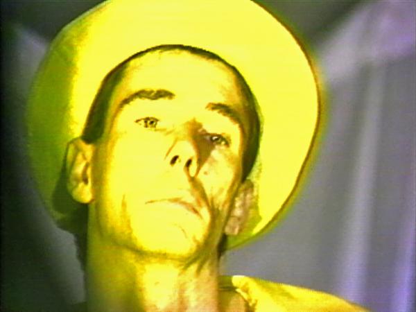 Mike Kelley, Visual Arts Center, close-up film still of yellow man in yellow hat 
