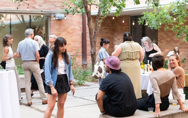 people in courtyard at art opening