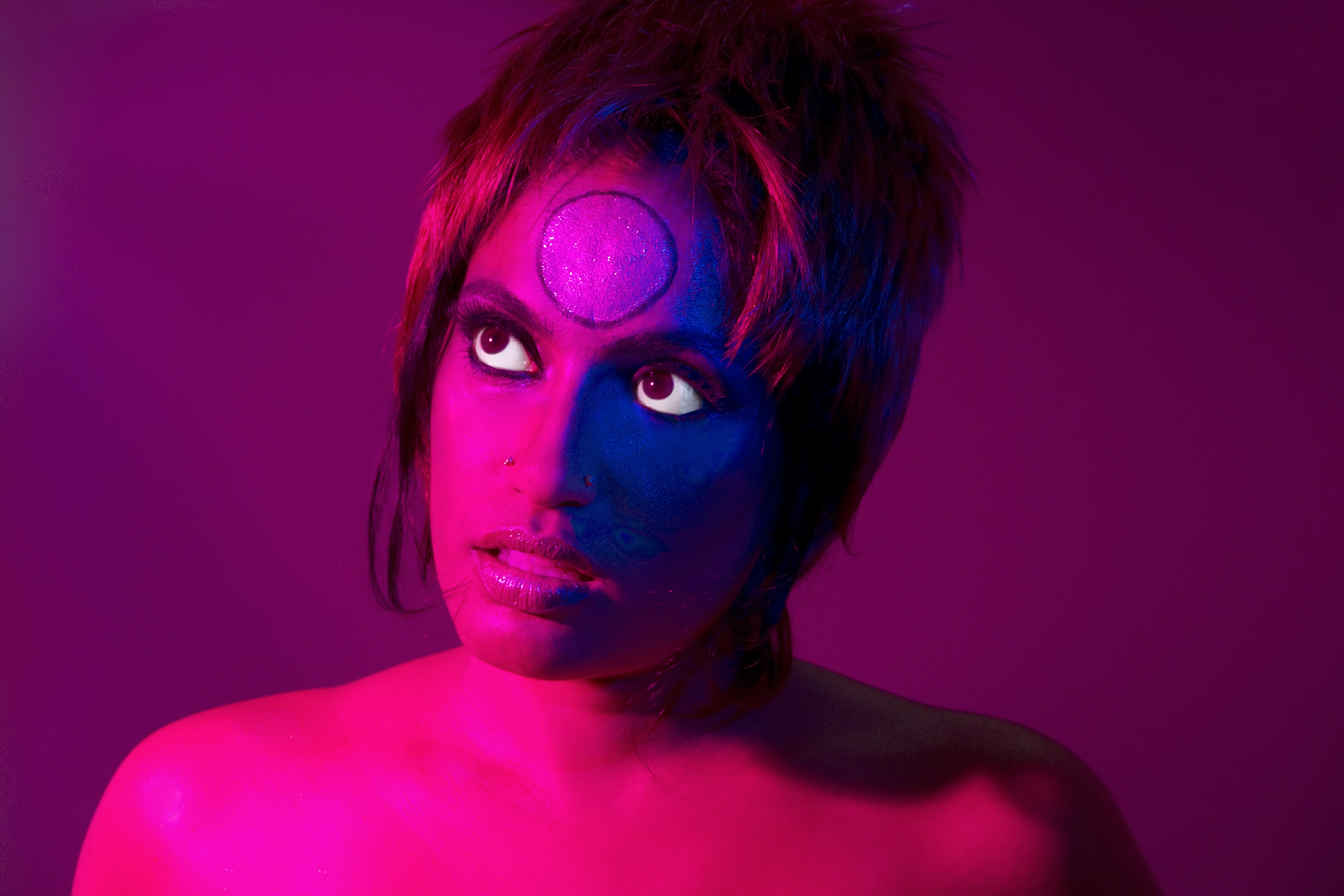 Elia Alba, Visual Arts Center, close-up portrait of woman with pink lighting