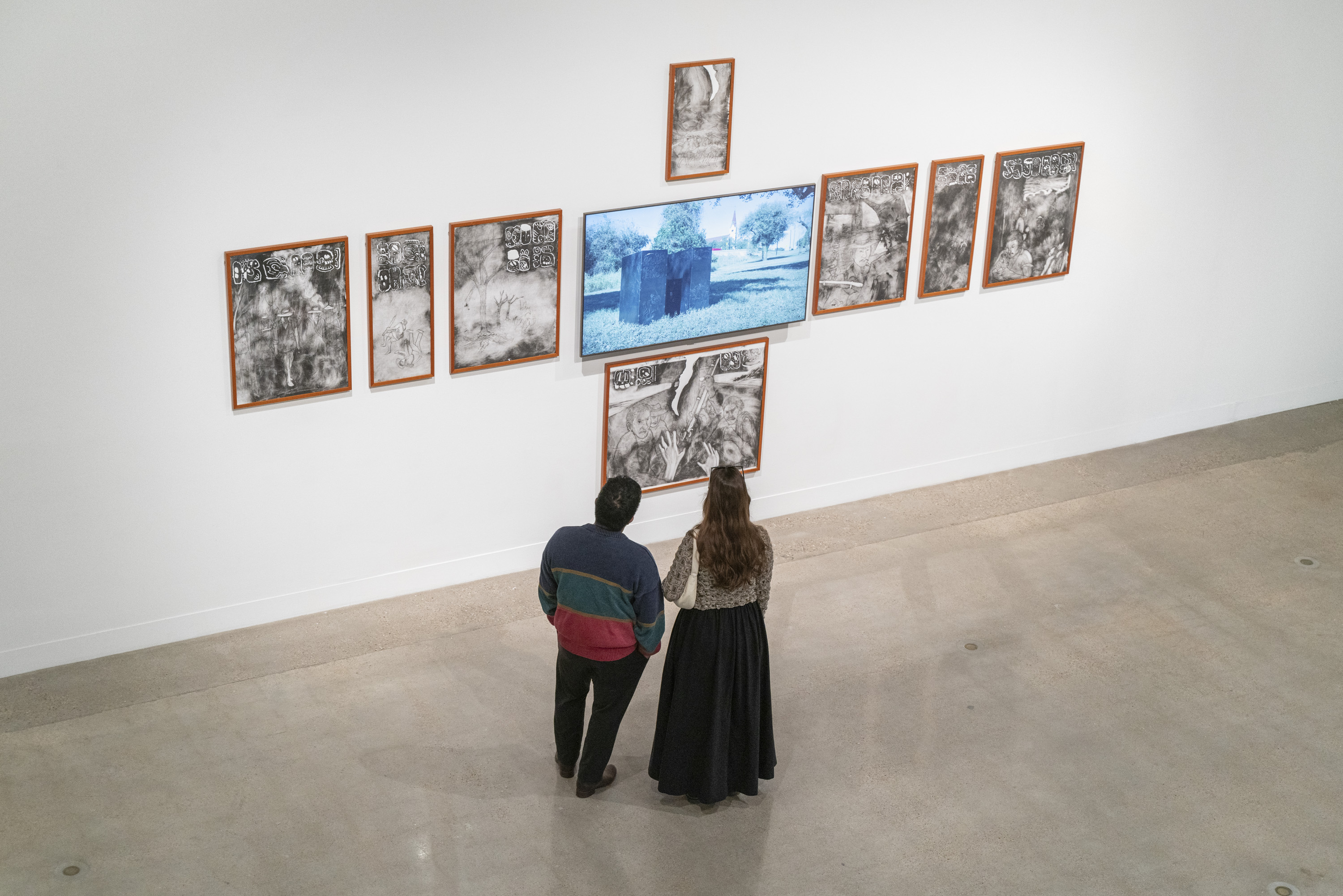 image of two people looking at an installation