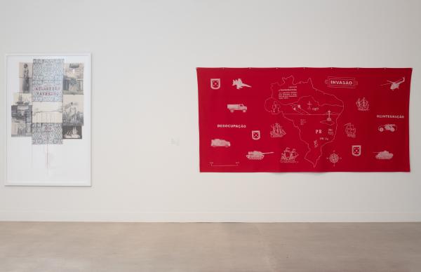 two textiles, left one framed, right one bright red with white painting on it