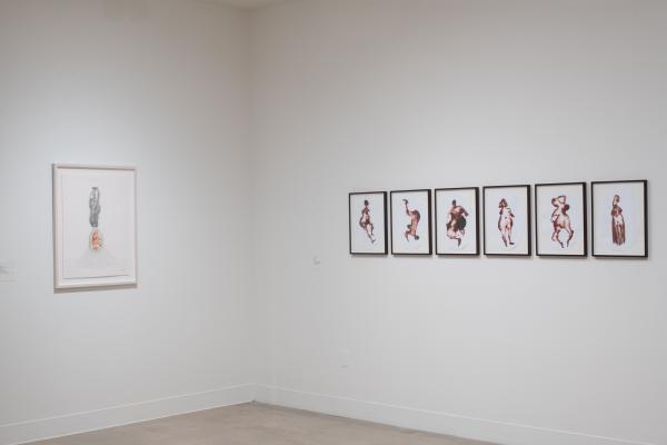 corner of gallery featuring work by two different artists on each side, one drawing, one watercolor