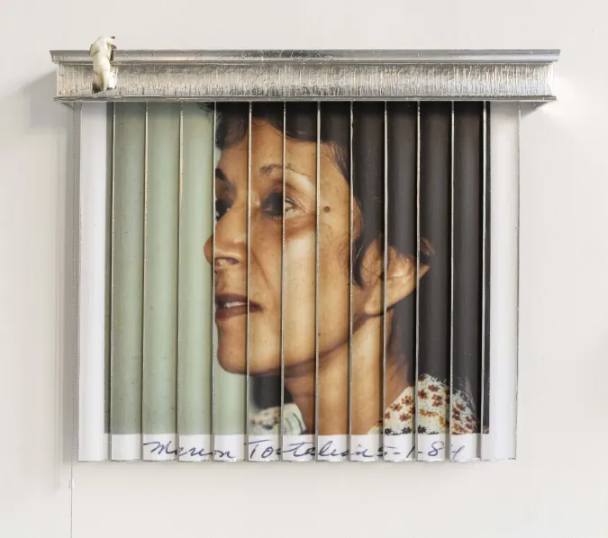 Image of a photo of a woman on the wall. 