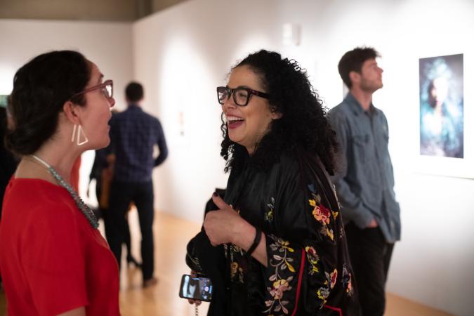 people talking at art gallery opening