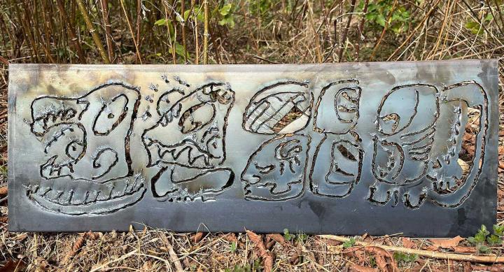 sheet of steel engraved with Maya glyphs